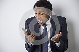 Surprised African American man with a phone