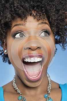 Surprised African American woman looking away with mouth open