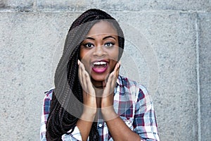 Surprised african woman looking at camera