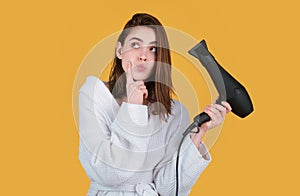 Surprised amazed woman hair dryer, drying hairstyle. Young girl with drying hair with hair dry.