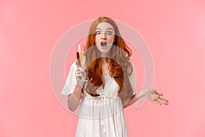 Surprised and amused, astounded redhead woman having interesting conversation, gossiping with friends during party