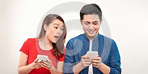 Surprised Asian couple watching the smartphone