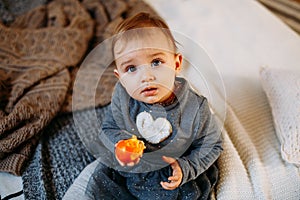 Surprised baby girl 1 year old. child`s eyes widened and mouth opened in amazement. Cute toddler girl. Top view