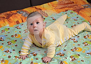 The surprised baby lies on a stomach