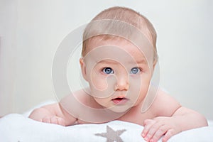 Surprised baby looks at camera