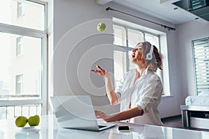 Surprised beautiful girl juggling with apples