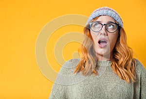 Surprised beautiful woman stare up , isolated on yellow background. Surprise expression face - head young girl. S