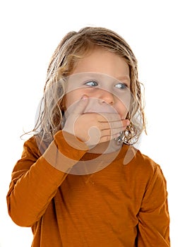 Surprised blond child with blue eyes covering his mouth