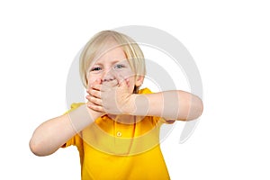 Surprised boy closes his mouth with his hand