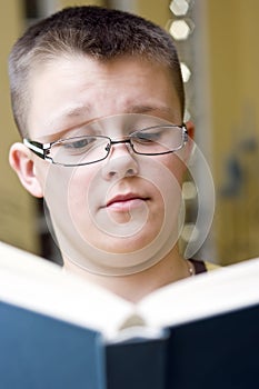 Surprised boy reading a book