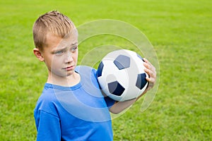 Surprised boy with soccer ball.