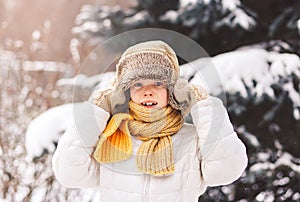 Surprised boy in winter on the street on a sunny day. Emotions