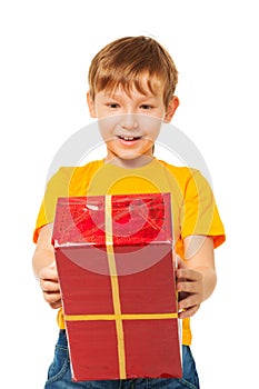 Surprised boy with wrapped box
