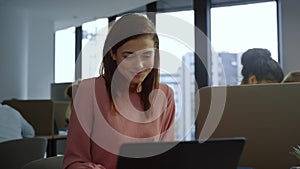 Surprised business woman looking at laptop computer . Lady showing yes gesture