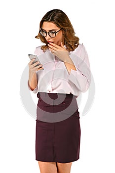 Surprised business woman looking at smart phone