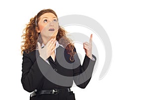 Surprised business woman pointing up