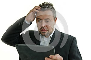 Surprised businessman looking at tablet screen