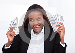 Surprised Businesswoman Holding Money Fan