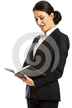 Surprised businesswoman reading her notes