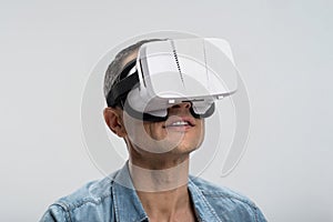 Surprised cheerful man trialing VR goggles