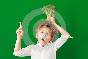 Surprised child against green chalkboard in class