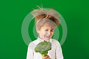 Surprised child against green chalkboard in class