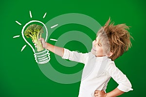 Surprised child against green chalkboard in class