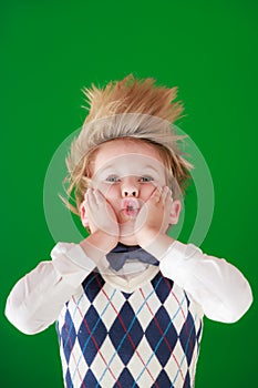 Surprised child against green chalkboard in class