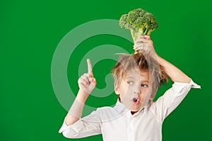 Surprised child against green chalkboard in class