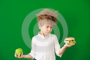 Surprised child against green chalkboard in class