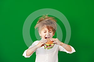 Surprised child against green chalkboard in class