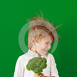 Surprised child against green chalkboard in class