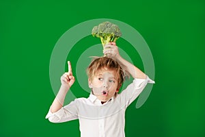 Surprised child against green chalkboard in class