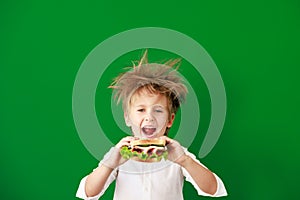 Surprised child against green chalkboard in class