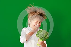 Surprised child against green chalkboard in class