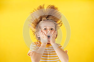 Surprised child against yellow background