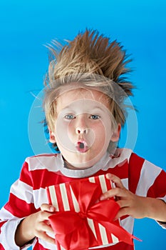 Surprised child holding Christmas gift