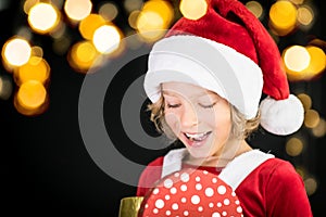 Surprised child holding Christmas gift box