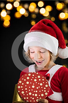 Surprised child holding Christmas gift box