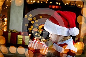 Surprised child opening Christmas gift