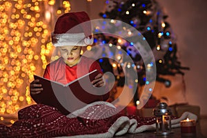 Surprised child opening magic Christmas book.