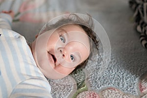 Surprised child. surprised kid sitting at table. child`s eyes widened and mouth opened in amazement. copy space for your text