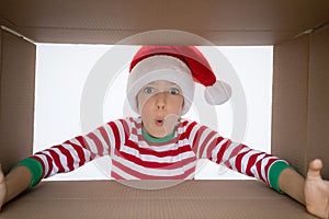 Surprised child unpack Christmas gift box