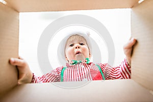 Surprised child unpack Christmas gift box