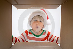 Surprised child unpack Christmas gift box