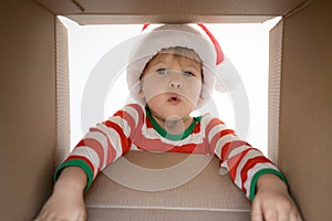 Surprised child unpack Christmas gift box