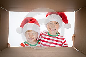 Surprised children unpack Christmas gift box