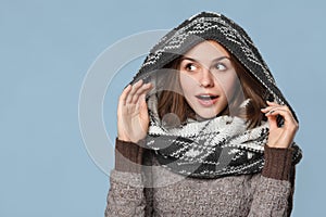 Surprised christmas girl wearing knitted wear scarf