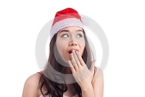 Surprised christmas woman wearing a santa hat isolated on white