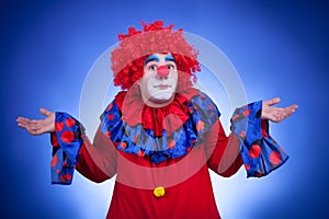 Surprised clown on blue background